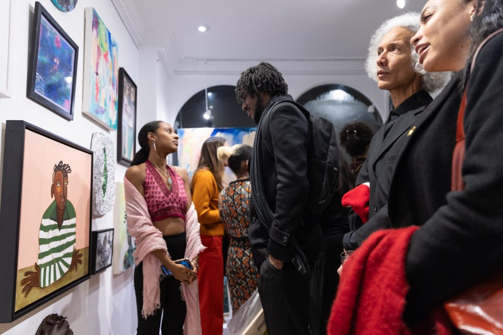 Visitors engaging with contemporary Black artwork at CasildART Contemporary